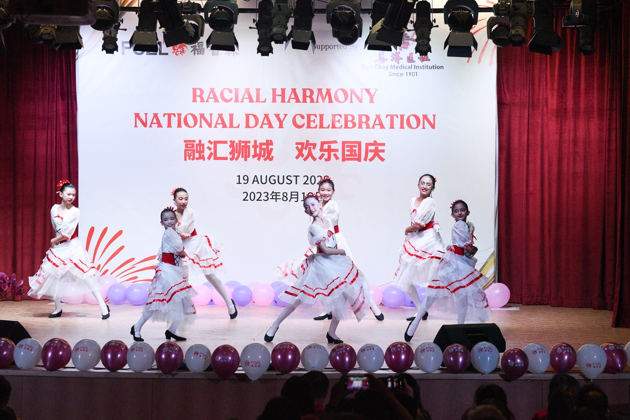 A group of women dancing on a stageDescription automatically generated