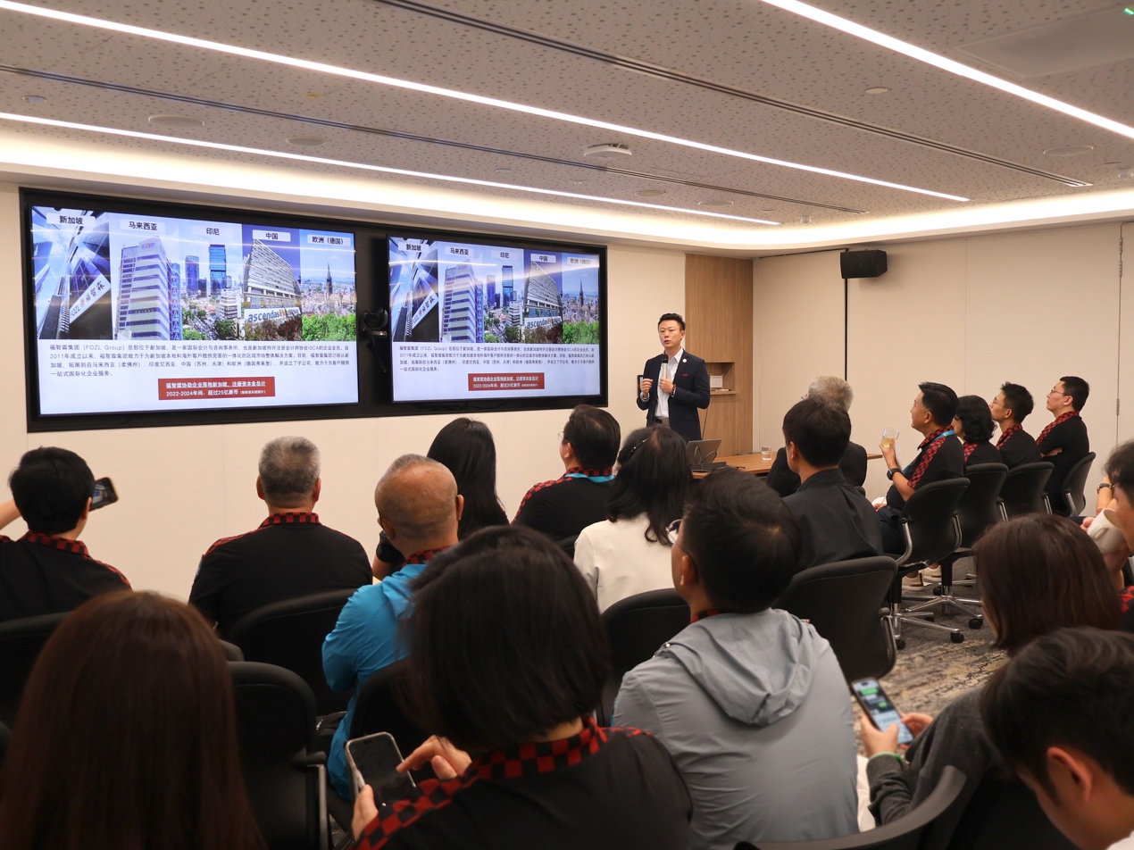 A person standing in front of a large screen AI-generated content may be incorrect.